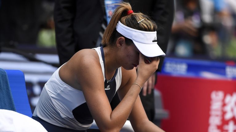 Garbine Muguruza of Spain gestures after retiring during the women's singles final against Venus Williams