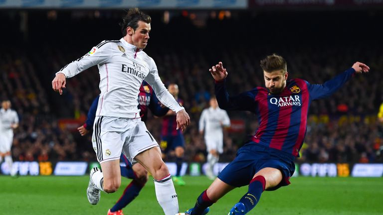 Gerard Pique of Barcelona tackles Real's Gareth Bale in one of last season's meetings between the sides