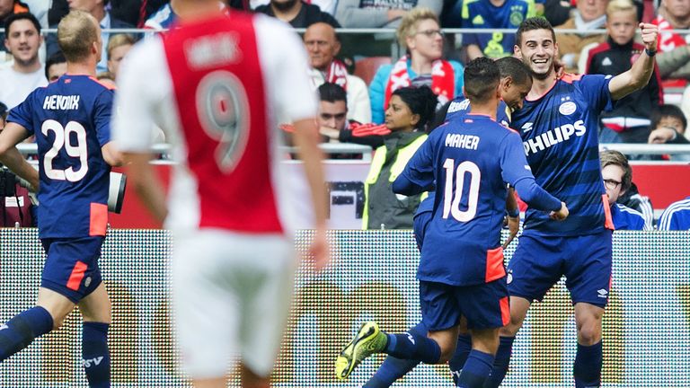 Gaston Pereiro (R) celebrates with his teammates after socring a goal during the Dutch Eredivisie football match between Ajax Amsterdam and PSV Eindhoven