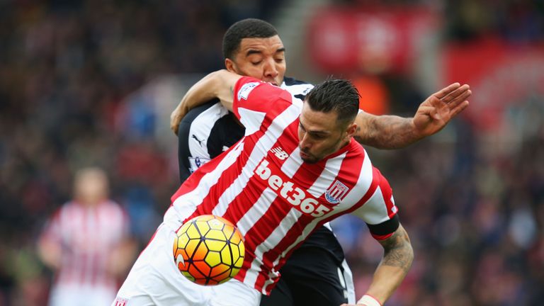 Geoff Cameron of Stoke City and Troy Deeney of Watford compete for the ball 