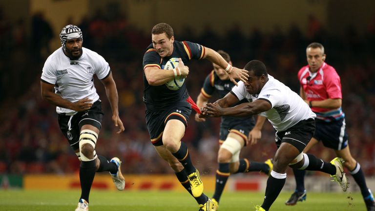 Wales' George North attempts to avoid the tackle from Fiji's Manasa Saulo (right)