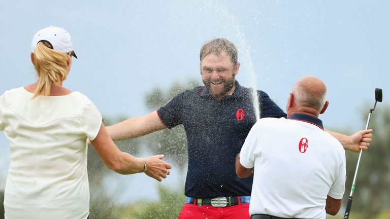 Andy Sullivan is sprayed with champagne after victory on the 18th green 