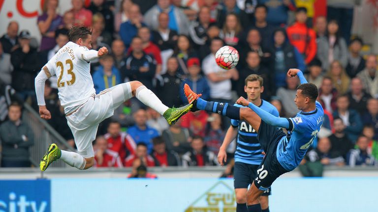 Gylfi Sigurdsson of Swansea City challenges Dele Alli of Tottenham 