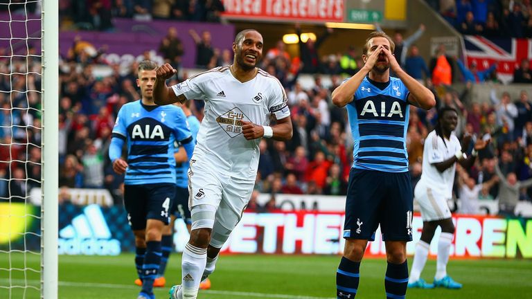 SWANSEA, WALES - OCTOBER 04:  Ashley Williams of Swansea City celebrates after Harry Kane of Tottenham Hotspur scores an own goal during the Barclays Premi