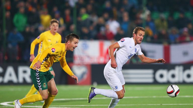 Harry Kane of England is chased by Linas Klimavicius of Lithuania