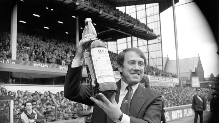 Everton manager Howard Kendall lifts the giant bottle of whiskey, his prize for winning  Manager of the Year in 1985