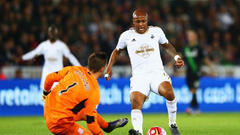 Andre Ayew of Swansea City is challenged by goalkeeper Jack Butland of Stoke City