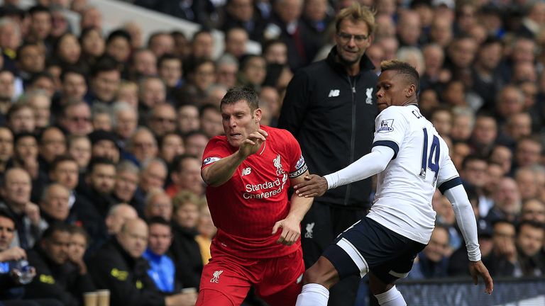 Liverpool's James Milner and Tottenham Hotspur's Clinton N'Jie battle for the ball as Liverpool manager Jurgen Klopp looks on 