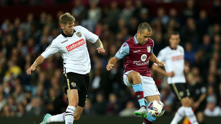 BIRMINGHAM, ENGLAND - AUGUST 25: Jole Cole of Aston Villa is closed down by Jonathan Stead of Notts County during the Capital One Cup second round match be