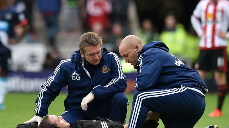 Sunderland's John O'Shea is treated for an injury before being brought off 