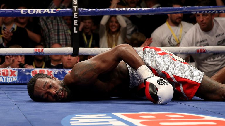 MANCHESTER, ENGLAND - OCTOBER 10:  John Thompson of The USA lies on the canvas after being knocked down by Liam Smith of Great Britain leading to the end o