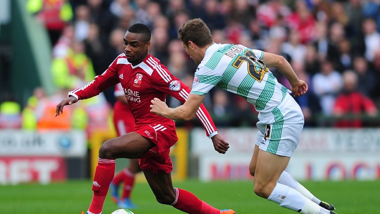 Jon Obika of Swindon Town (L) holds off Ben Nugent of Yeovil Town