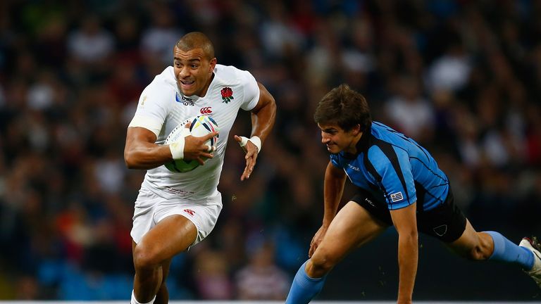 MANCHESTER, ENGLAND - OCTOBER 10:  Jonathan Joseph of England evades Manuel Blengio of Uruguay during the 2015 Rugby World Cup Pool A match between England