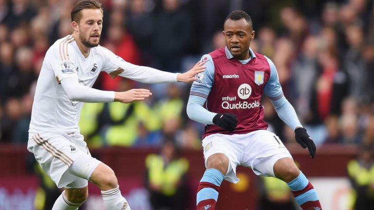 Jordan Ayew and Gylfi Sigurdsson compete for the ball