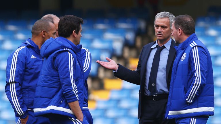 Chelsea manager Jose Mourinho debriefs his staff on the pitch after their team's 3-1 defeat to Liverpool