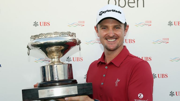 Justin Rose celebrates with the trophy after winning the UBS Hong Kong Open