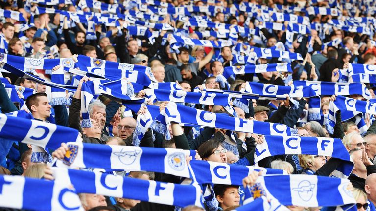 Leicester City supporters raise their scarves during the match against West Brom