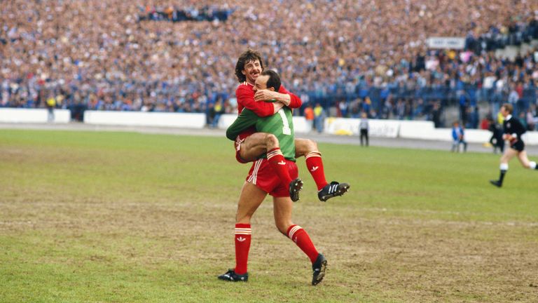 Liverpool defender Mark Lawrenson celebrates with goalkeeper Bruce Grobbelaar after Liverpool won the 1985/86 First Division Title at Chelsea 