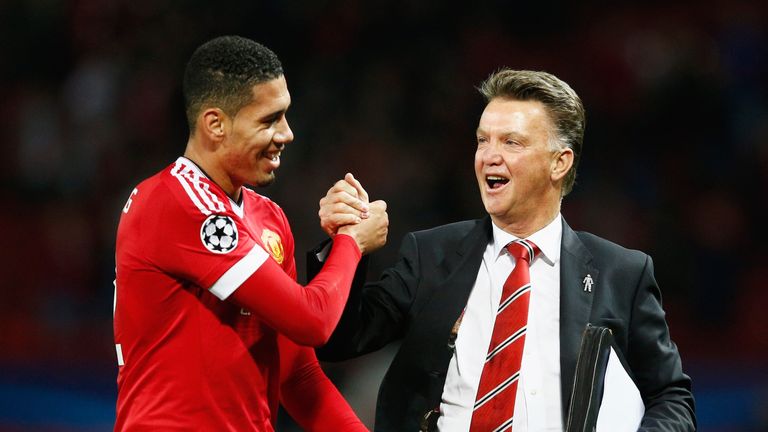 Louis van Gaal celebrates victory victory over Wolfsburg with Chris Smalling