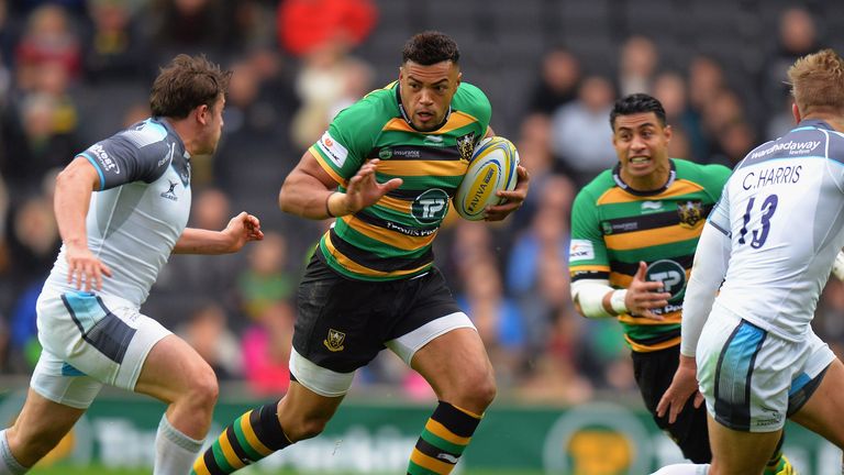 Luther Burrell of Northampton Saints is tackled by Adam Powell of Newcastle Falcons 