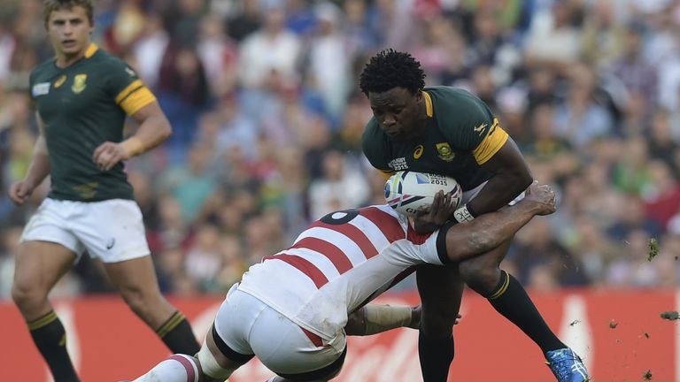 South Africa's wing Lwazi Mvovo (R) is tackled during a Pool B match of the 2015 Rugby World Cup between South Africa and Japan