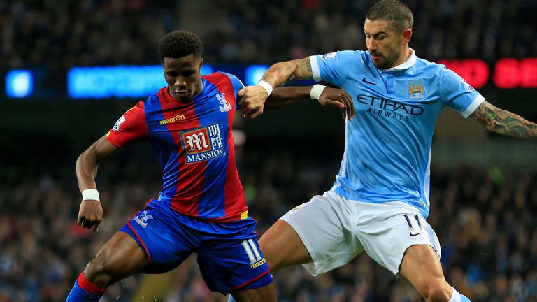 Crystal Palace's Wilfried Zaha (left) and Manchester City's Aleksandar Kolarov battle for the ball during the Capital One Cup, Fourth Round match at the Et