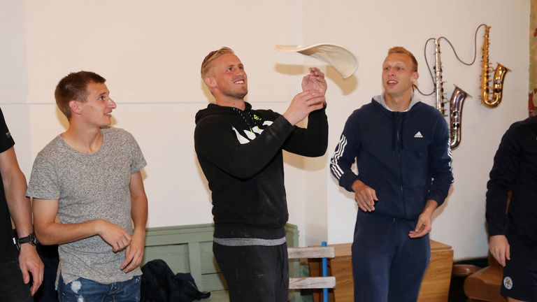 Marc Albrighton (left) and Ritchie De Laet (right) watch Kasper Schmeichel attempt to make a pizza