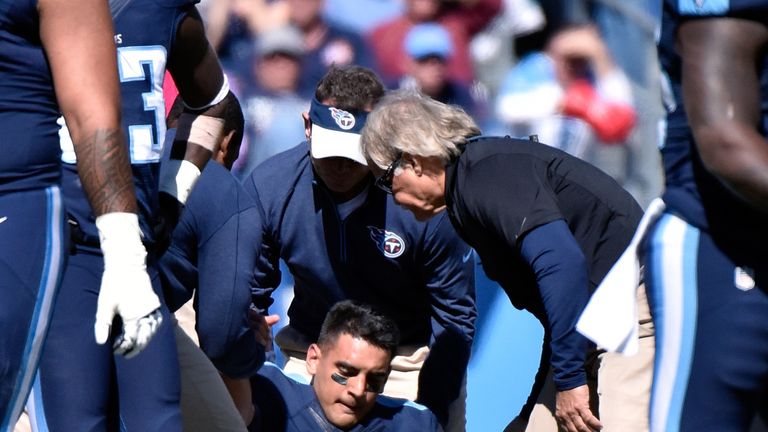 Titans quarterback Marcus Mariota is attended to by medical staff after receiving a late hit by Olivier Vernon.