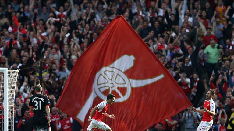 Arsenal's Mesut Ozil (centre) celebrates hs goal in front of the home fans