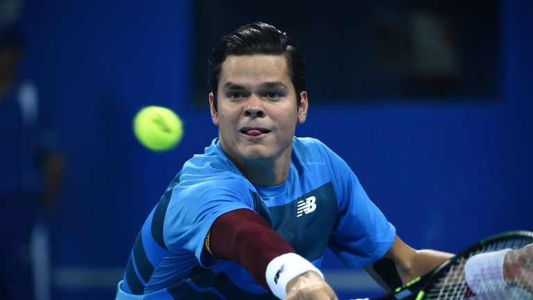 Milos Raonic of Canada hits a return against Viktor Troicki