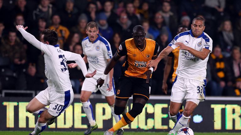 Mo Diame of Hull City (C) is challenged by Benjamin Chilwell (L) and Gokhan Inler of Leicester City during the Capital One Cup fourth round match