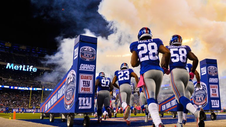 Members of the New York Giants run onto the field before a game against the San Francisco 49ers at MetLife Stadium