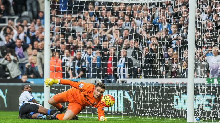 NEWCASTLE, ENGLAND - OCTOBER 31:   Stoke City goalkeeper Jack Butland (R) looks at the ball after it hits the goalpost whilst Georginio Wijnaldum (L) of Ne