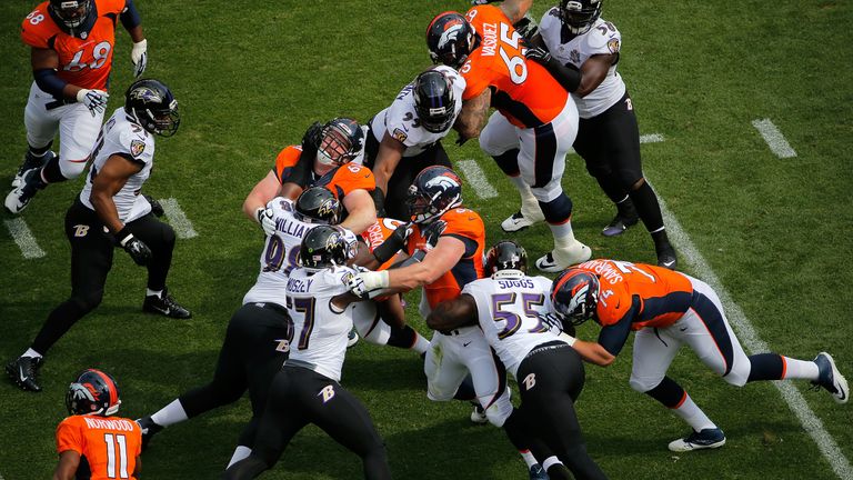 C.J. Anderson of the Denver Broncos carries the ball as the Denver Broncos offense battles on the line of scrimmage
