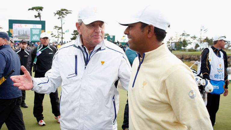 INCHEON CITY, SOUTH KOREA - OCTOBER 11:  Captain Nick Price (L) chats with Anirban Lahiri of India and the International Team after the Sunday singles matc