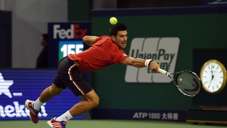 Novak Djokovic of Serbia reaches for a return during his men's singles quarter-final match against Bernard Tomic