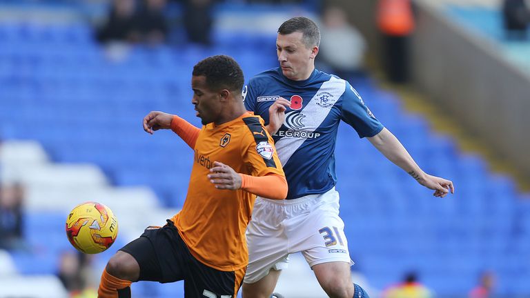 Birmingham City's Paul Caddis and Wolverhampton Wanderers' Nathan Byrne (left) battle for the ball