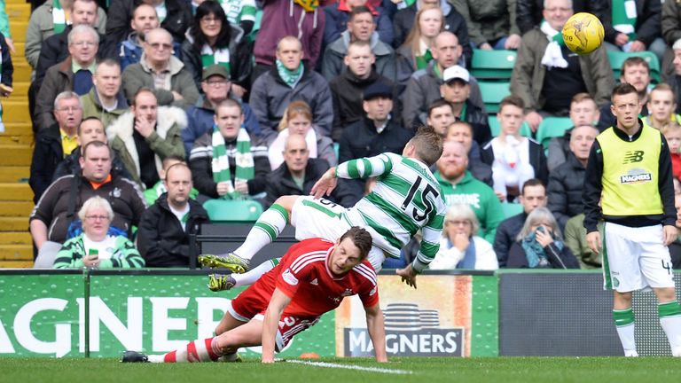 Aberdeen's Ash Taylor scythes down Kris Commons to concede a penalty at Celtic Park