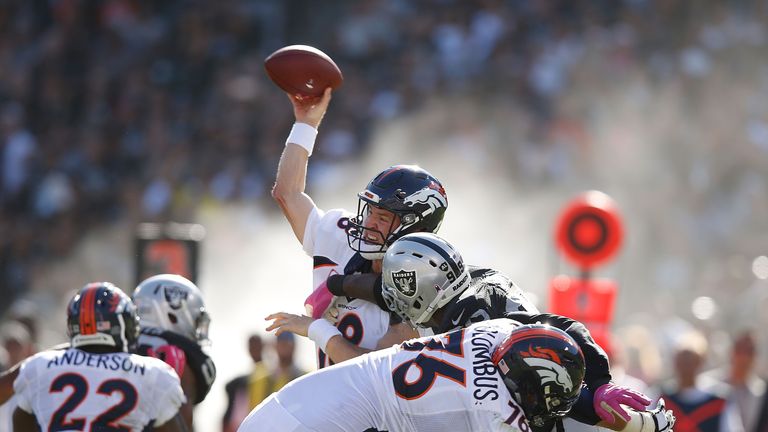 Peyton Manning #18 of the Denver Broncos throws downfield in the fourth quarter against the Oakland Raiders at O.co Coliseum on O
