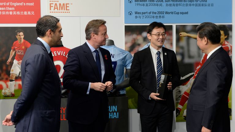 China's President Xi Jinping (R) and Britain's Prime Minister David Cameron (2L) are introduced to former Manchester City Sun Jihai 
