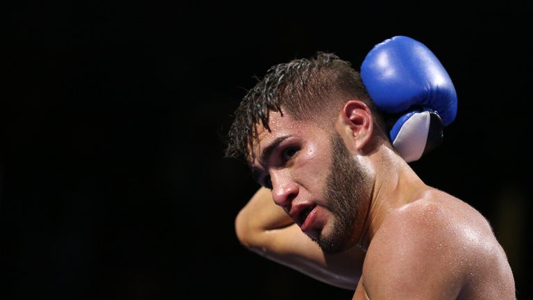 Prichard Colon holds the back of his head during his welterweight clash with Terrel Williams