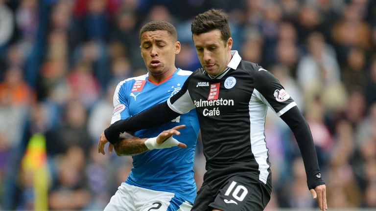 Rangers' James Tavernier (left) battles with Queen of the South's Ryan Conroy (right)