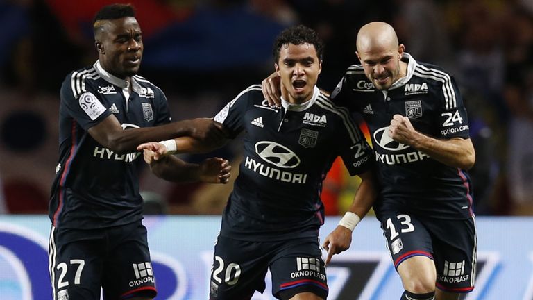 Lyon's French defender Rafael Pereira Da Silva celebrates (C) with teammates