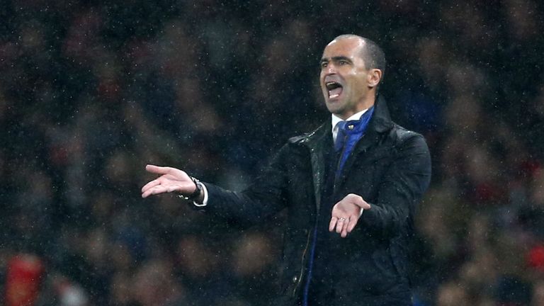 Everton's Spanish manager Roberto Martinez gestures in the rain during the English Premier League football match between Arsenal and Everton 