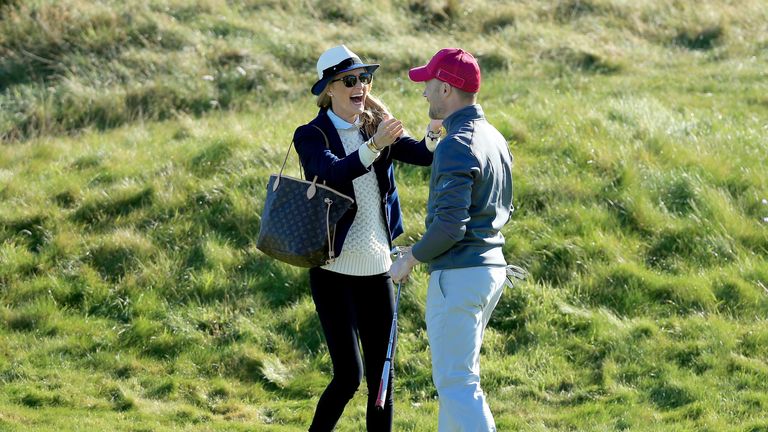 CARNOUSTIE, SCOTLAND - OCTOBER 01: Ronan Keating of Ireland  is congratulated by his wife Storm Keating after he had holed a par putt on the second hole du