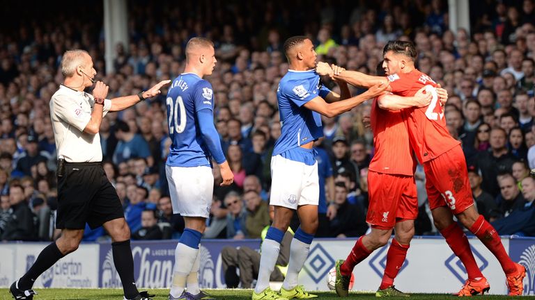 Liverpool's James Milner (Second right) holds back Emre Can after an altercation with Everton's Ross Barkley - for which both players were booked