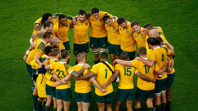 The Australia team huddle after their victory over Scotland