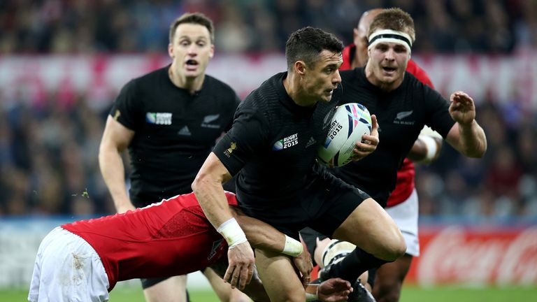 New Zealand fly-half Dan Carter is tackled by Siale Piutau
