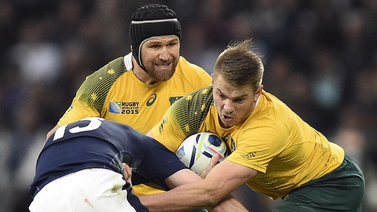 Australia wing Drew Mitchell (right) is tackled by Scotland centre Mark Bennett next to Matt Giteau