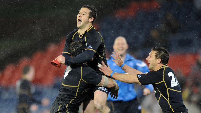 Scotland fly-half Greg Laidlaw celebrates with Ross Rennie and Chris Cusiter after kicking the winning penalty against Australia in 2012